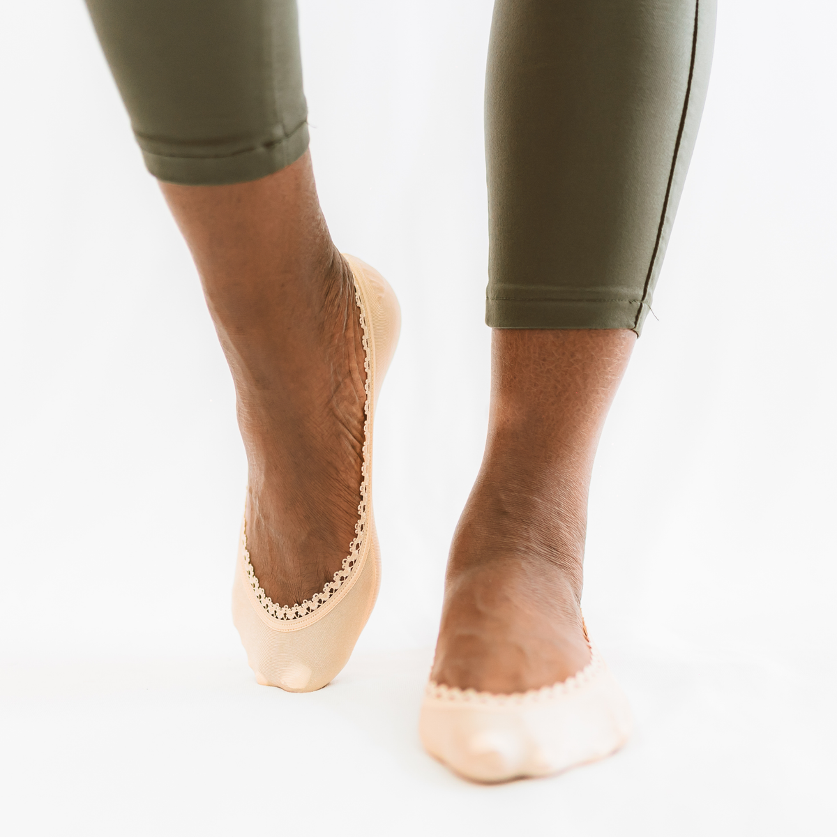 Black woman wearing nude/beige footies with casual pants - Arnacci comfortable everyday look