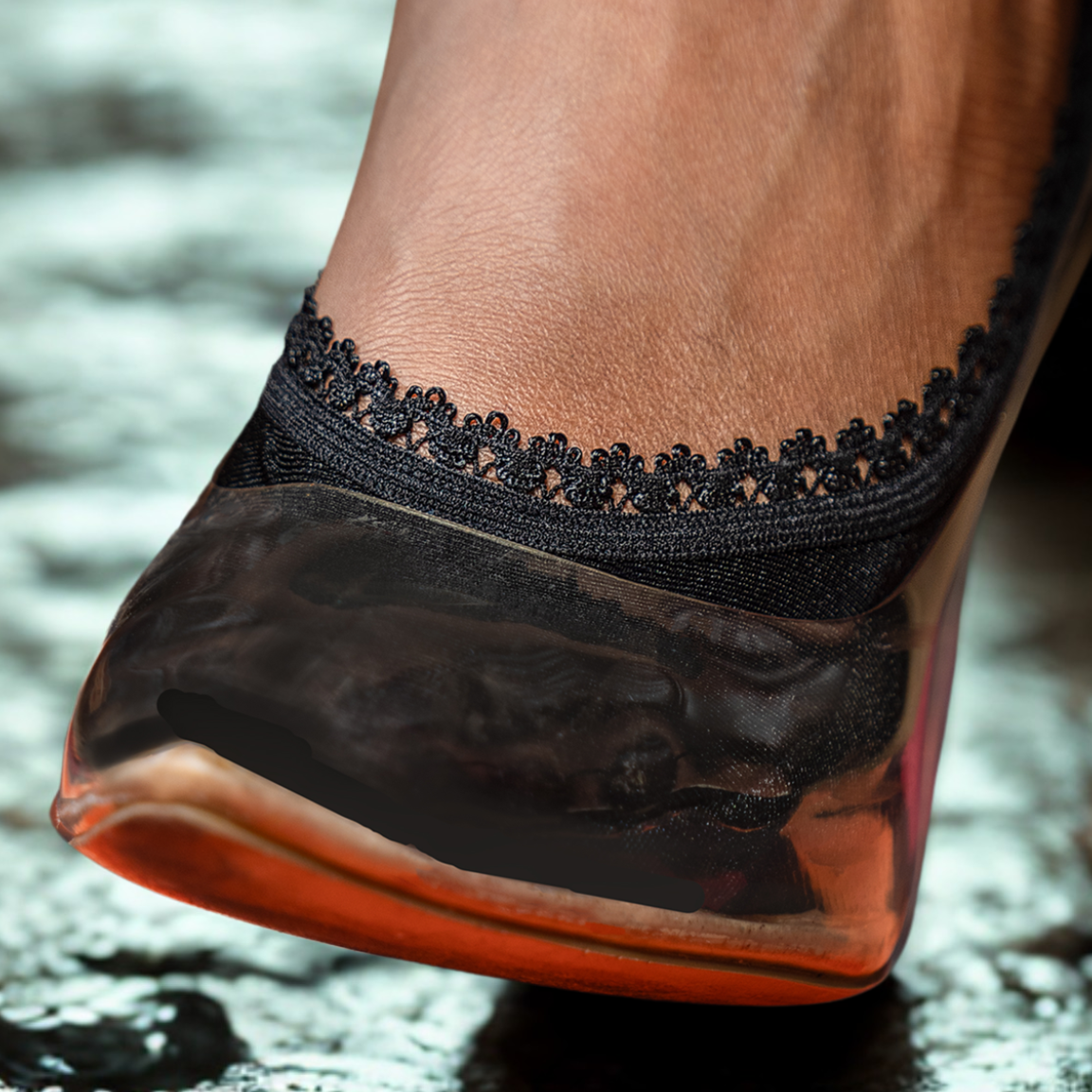 Close-up of black footie peeking out of trendy heel - Arnacci night out style