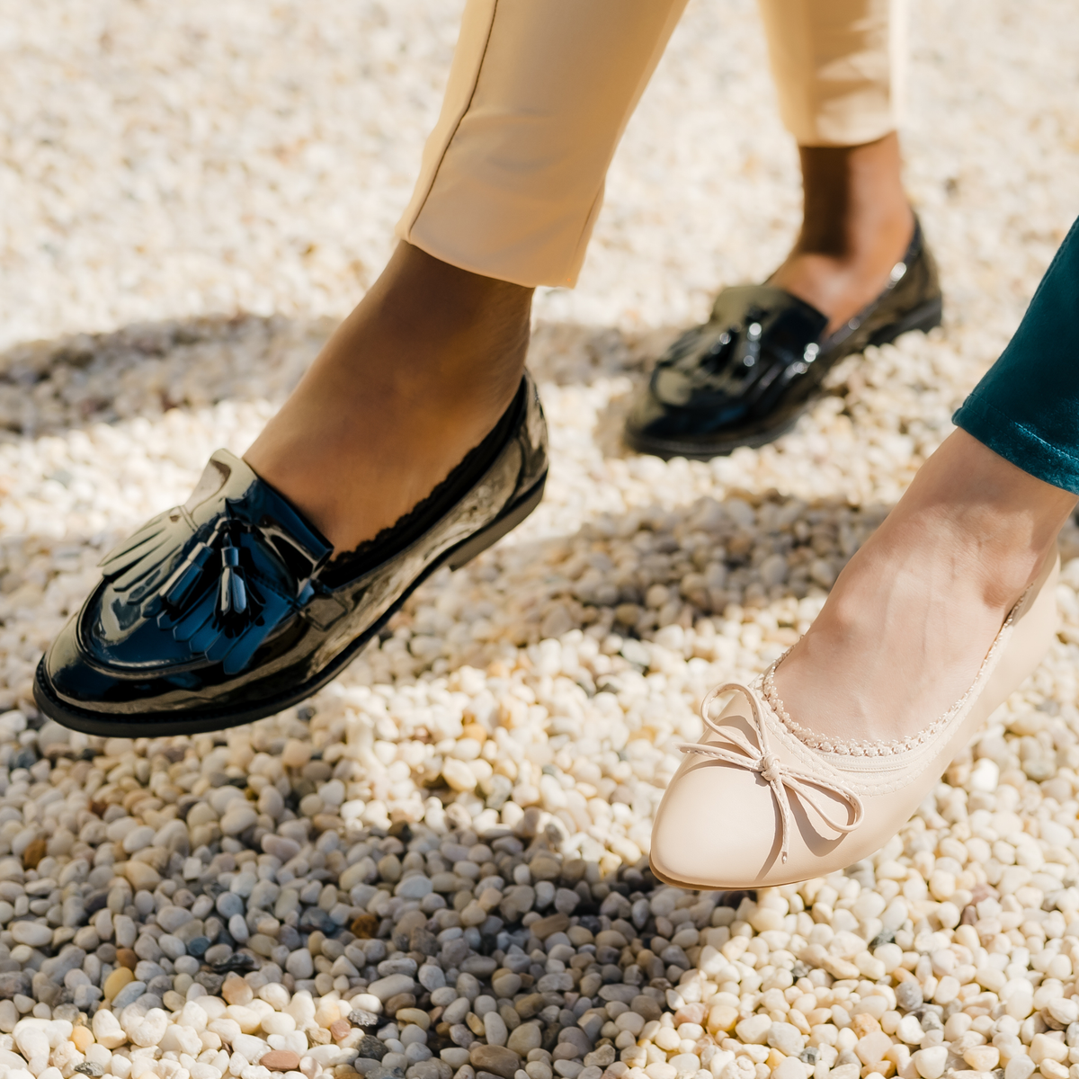 Two women posing playfully in Arnacci no-show footies - black loafers and nude shoes showing stay-put design