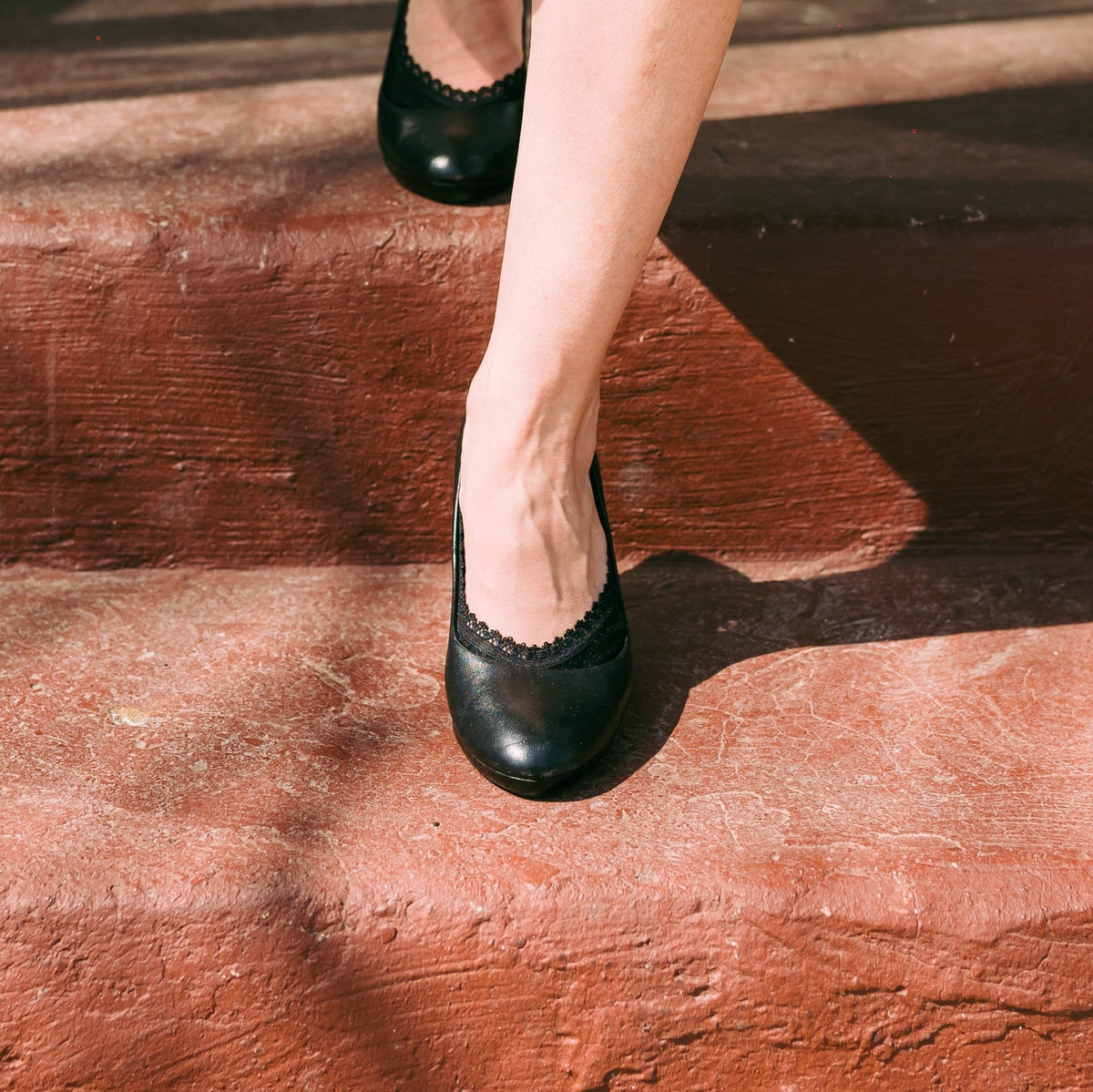 White woman wearing Arnacci black footies with black heels - professional work
