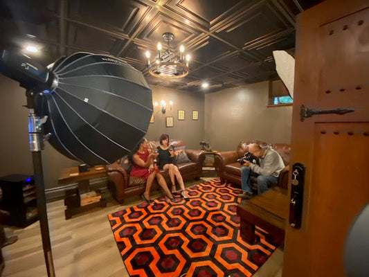 Behind the scenes of photo shoot used in Arnacci blog in home studio with photography lighting and models on couches showing Arnacci low cut footies for dress shoes
