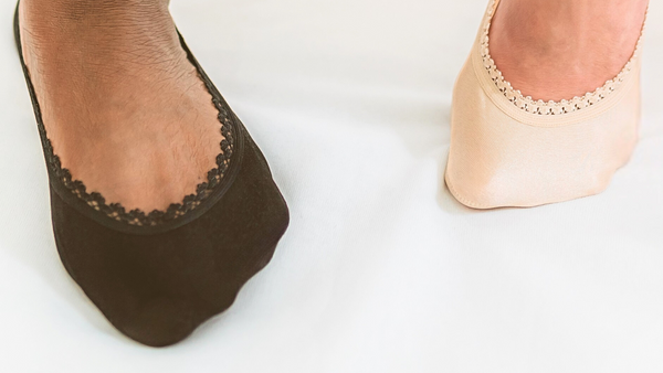 Close-up of two feet wearing lace-edged and nudes AND nude AND sand AND beiges in Sand and Espresso brown 