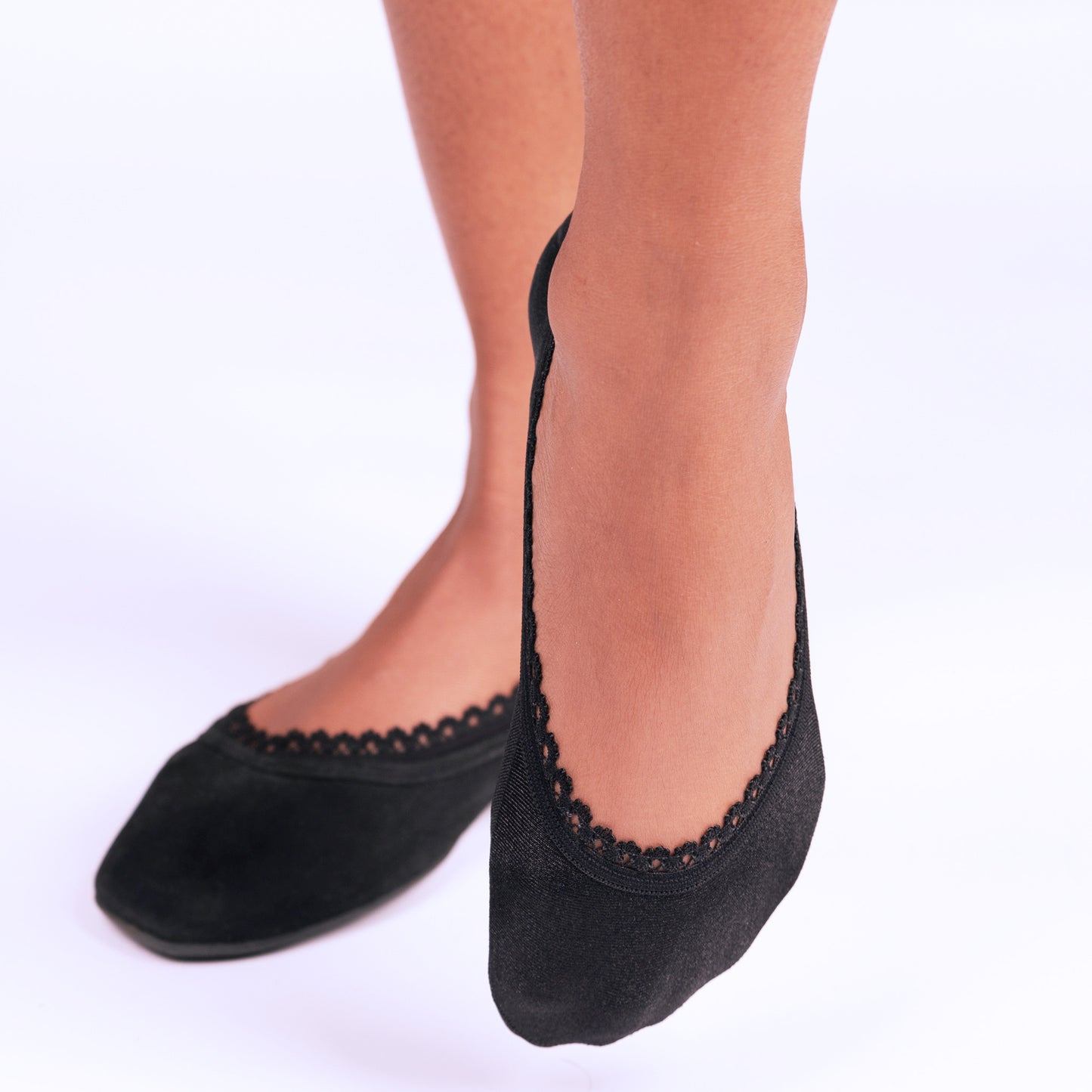 Black no-show footies on women's feet - Arnacci invisible socks worn with shoes