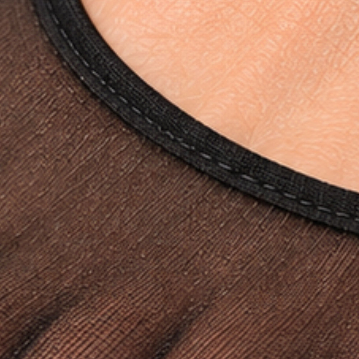 Close-up of a basic women's no-show footie sock made with thin, sheer black nylon fabric and a plain edge.