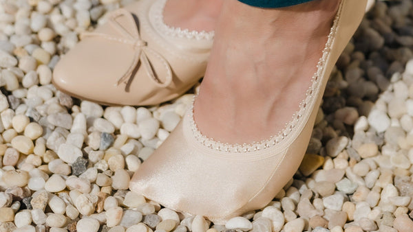 Sand or nude non-slip no-show socks with lace trim protecting the top of the foot in ballet flats