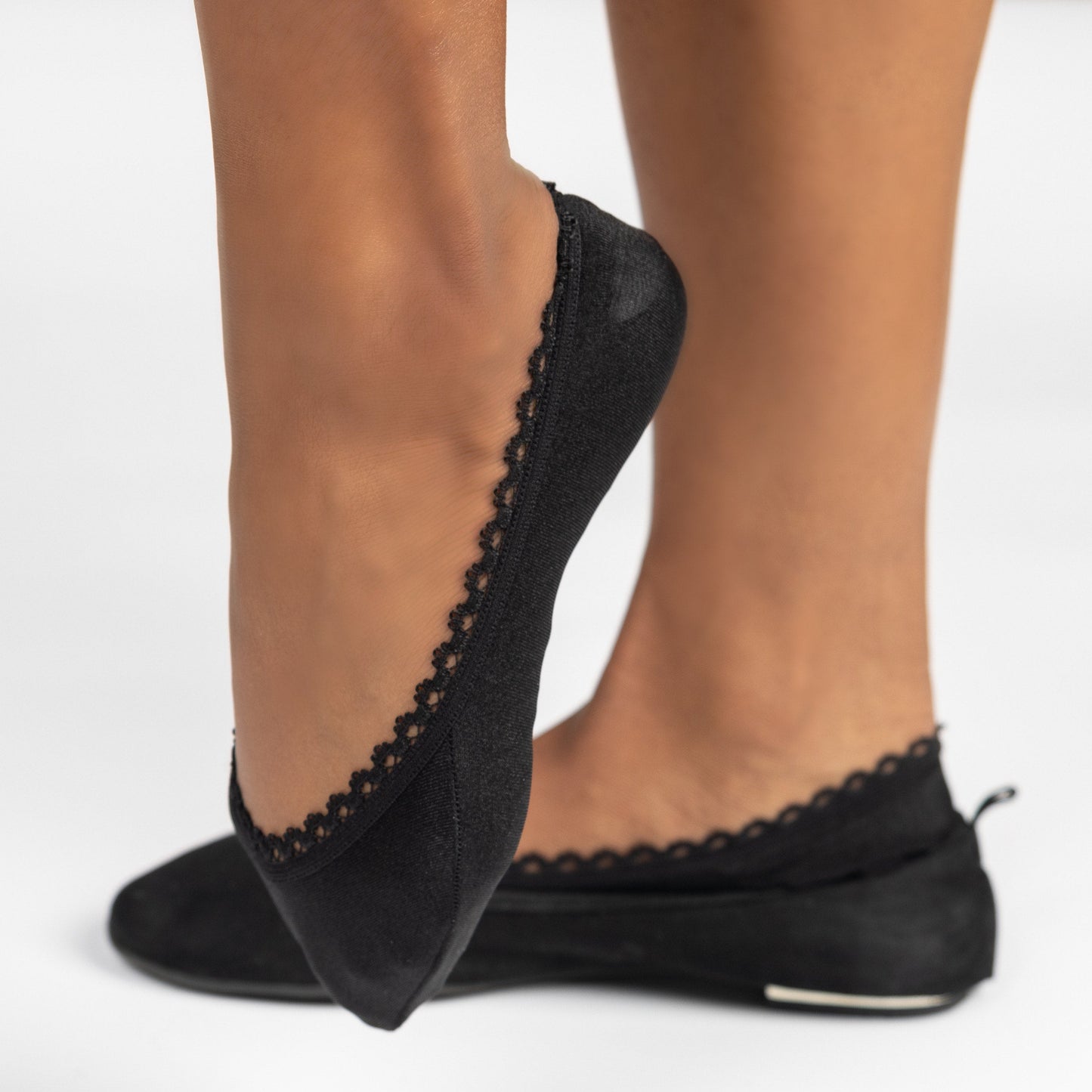 Side view of black woman wearing black ballerina flats with Arbella Style footie - elegant no-show sock