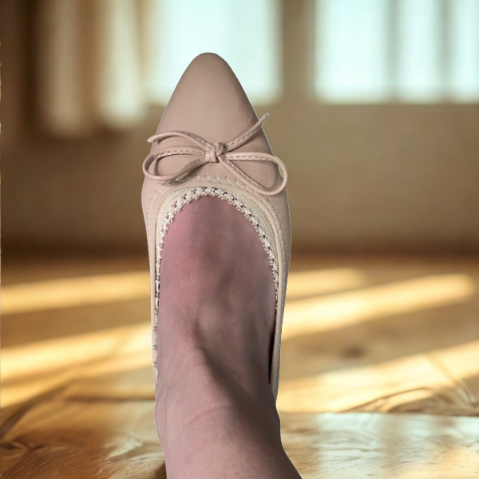 White woman wearing nude ballerina flat with lace edge peeking out - Arbella Style beige footie detail