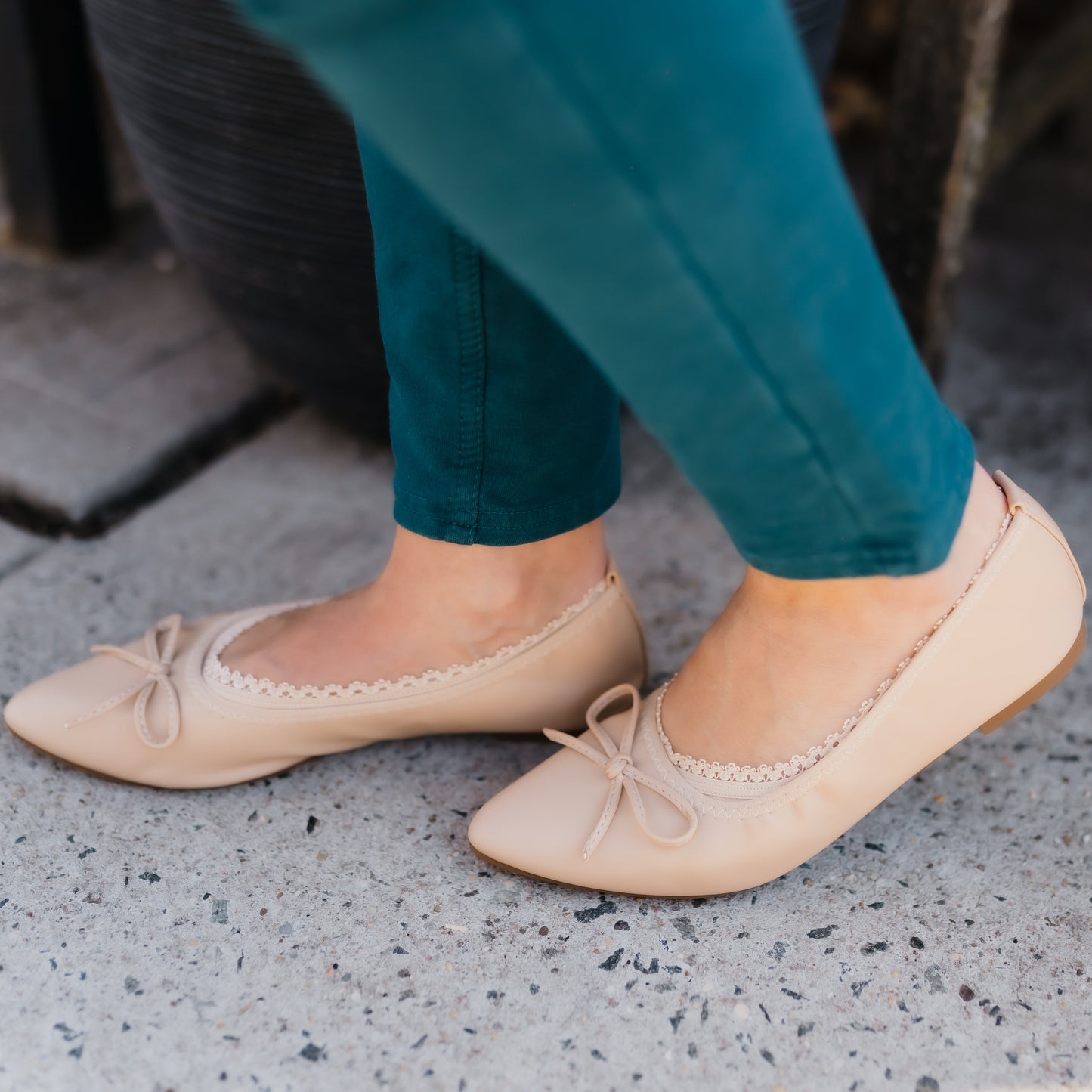 Side view of white woman wearing nude ballerina flats with lace edge peeking out - Arbella Style casual look