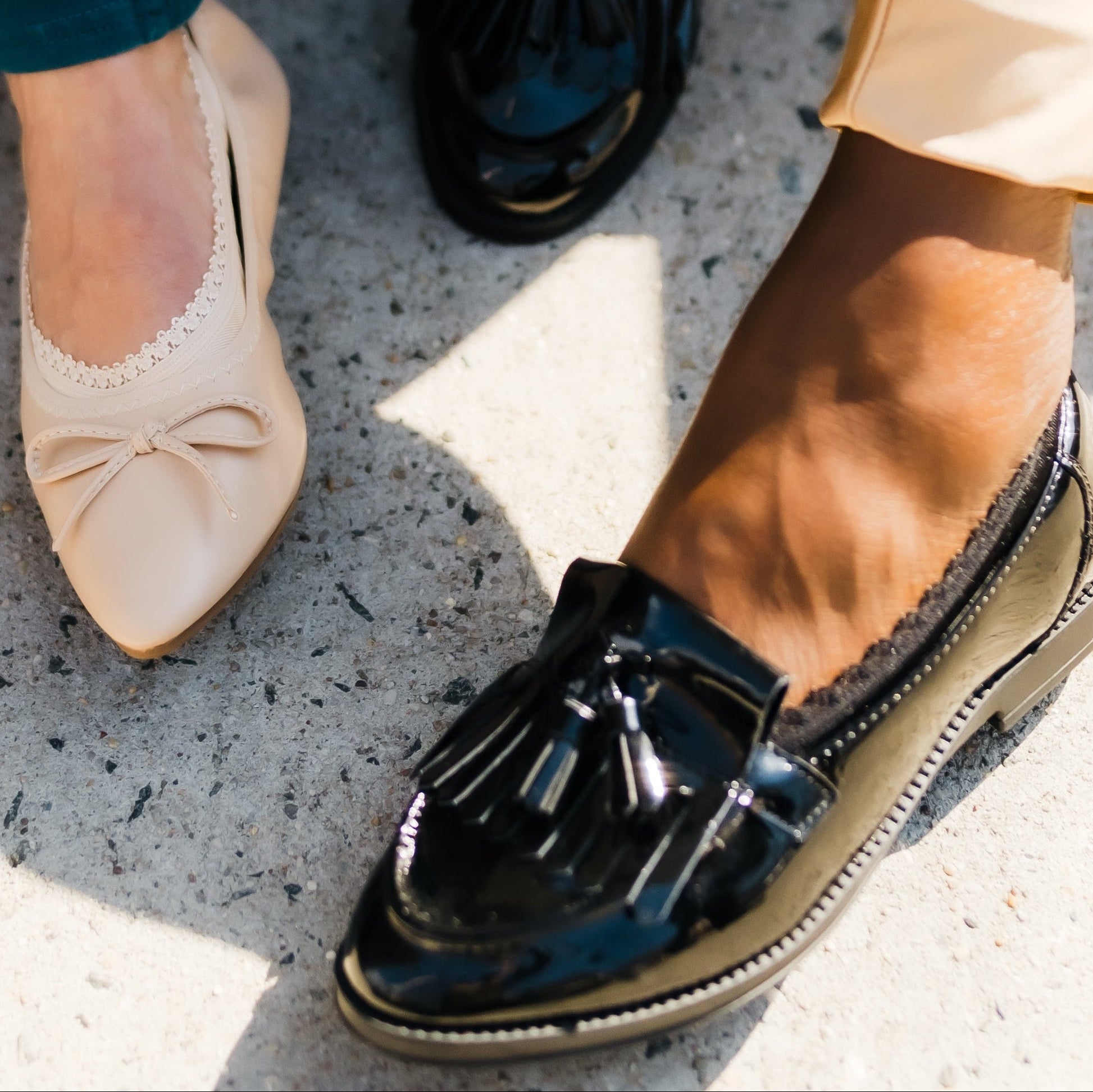 White woman in nude ballerina flat and African American woman in black loafer - Arbella Style casual footies