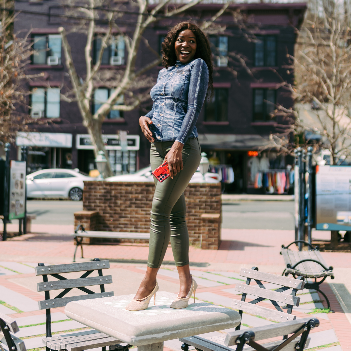 Woman standing powerfully on table wearing sand heels with footies - Arbella Style casual day confidence